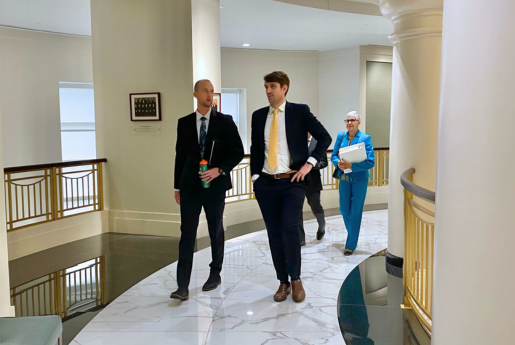 two lawyers walking and talking in a courthouse